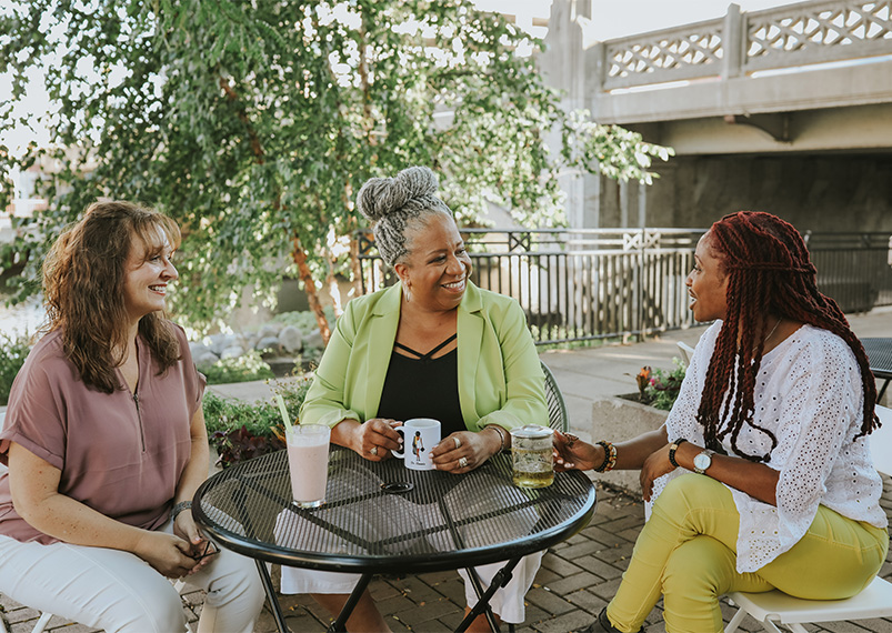 Dr Bonnie consulting with two women on their executive leadership.